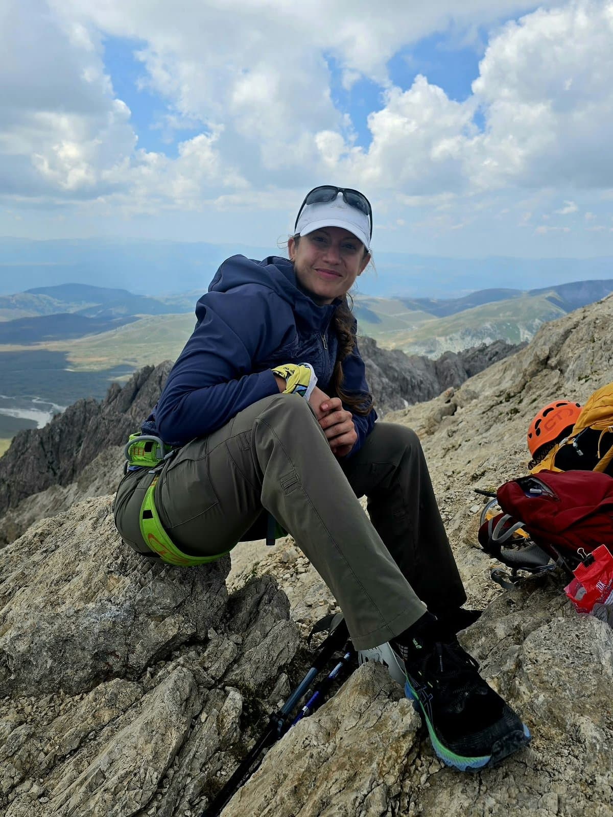 Diana França resting on a rocky mountain summit