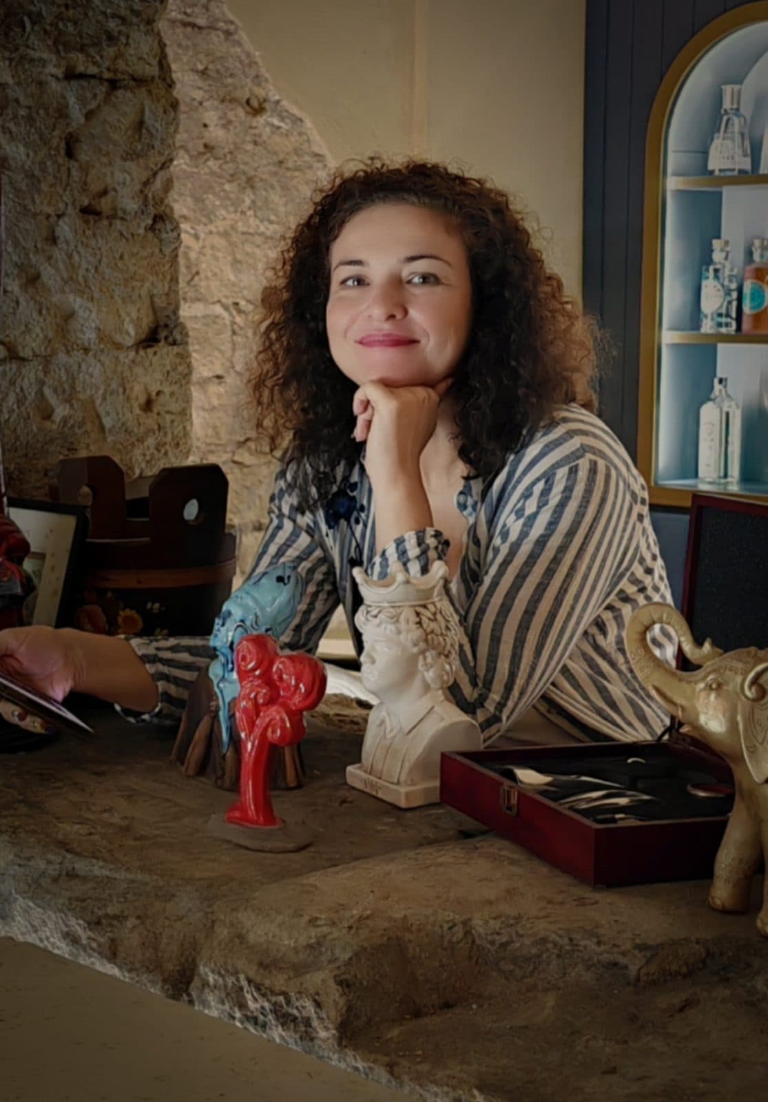 Katya Velikova seated at a stone counter